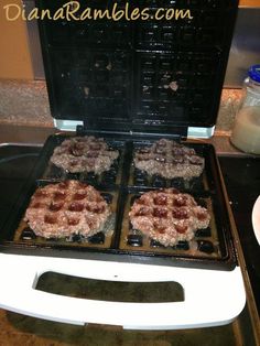 four waffles are being cooked on an electric griddle