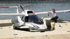 a man sitting on the dock next to a small plane