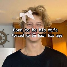 a young man wearing a black shirt with a white bow on his head and text that reads, born to be his wife forced to be half his age