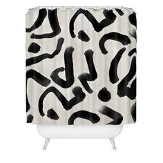 a shower curtain with black and white paint strokes on the outside, in front of a white background