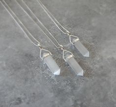 "Genuine selenite necklace. Selenite point pendant set in sterling silver hanging from a sterling silver chain in the style and length of your choice. Such a great layering necklace. Selenite is a white almost translucent stone that is also very reflective! Item description: Stone: Selenite Metal: Sterling Silver Shape: Point Size: Size: 1 1/4\"-1 3/8\" long and 1/4\"-3/8\" wide (approximate) Chain: Cable, Satellite, Open Link, Box - Cords: Braided Leather, Satin or Leather Length: 16\" to 36\" Minimalist White Quartz Crystal Necklace, Minimalist White Sterling Silver Crystal Necklace, Selenite Necklace, Braided Leather, Pendant Set, Gemstone Necklace, Layered Necklaces, Sterling Silver Chains, Crystal Healing