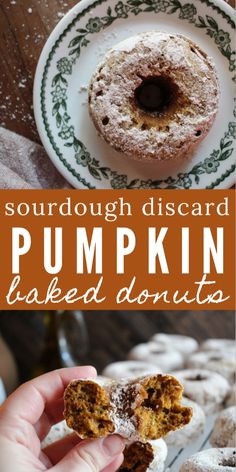 a person holding up a piece of pumpkin baked donuts with powdered sugar on top