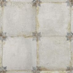 an old tile floor with grey and white flowers on the bottom half, in a square pattern