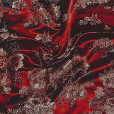 a red and black fabric with flowers on it