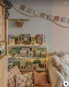 a bed room with a neatly made bed and lots of books on the shelves next to it