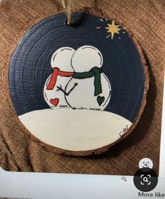 a wooden ornament with a snowman on it