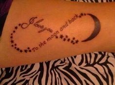 a woman with a tattoo on her arm that says, i love you to the moon and back