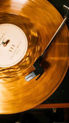 an old record player with gold colored vinyl