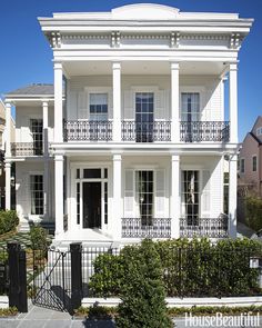 a large white house with many windows and balconies