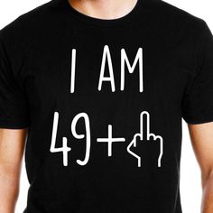 a man wearing a black t - shirt that says i am 29 + 1 and pointing to the left