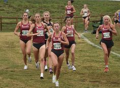 a group of women running in a cross country race