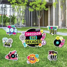 there are many signs in the grass with stickers on them that say through the decades