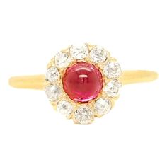 A fine stick pin conversion ring.  In 14 karat gold.   Center-set with a sugarloaf (lab created) ruby cabochon and prong-set with 10 single-cut white diamonds.  This ring is likely constructed from an antique stickpin that has been high-set on an 18k gold band.  Simply a wonderful jewelry creation!  Date: 20th Century  Overall Condition: It is in overall good, as-pictured, used estate condition. There is some light edge wear, some fine and light surface scratches, and other signs of light wear consistent with age.  Fineness: Professionally tests at 14k or higher  Marks: Marked 18k for gold fineness.  Ring Size: ca. 5 1/4  Gemstone Measurements: 1 Synthetic Ruby: ca. 4.75mm diameter 10 diamonds: ca. 2.25 diameter  Measurements: Height: ca. 27mm Width: ca. 19mm Depth: ca. 10mm  Weight: ca. 3 Ruby Cocktail, Sapphire Cocktail Ring, Vintage Cocktail Ring, Gold Cocktail Ring, Gold Cocktail, Diamond Cocktail Rings, Agate Ring, 14k Gold Ring, Garnet Rings