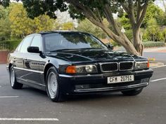 a black bmw parked in a parking lot