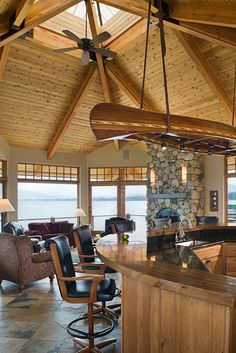 a large open living room and kitchen area with an island in front of the windows