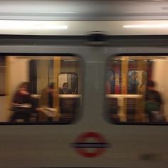 people are riding on the subway train at night