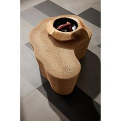 a wooden table with a bowl on top and some rocks in the middle that are inside