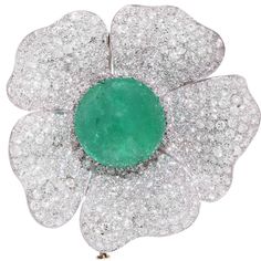 This stunning platinum brooch features a natural cabochon cut emerald weighing 33.93 carats set in a flower motif brooch which has 340 bead set round brilliant cut diamonds with an estimated total weight of 15 carats. This brooch was owned by the famous Greek actress Madame Kyveli, who at one time was married to George Papandreou, Prime Minister of Greece. Metal Type: Platinum Diamond Flower Brooch, Mint Candy, Van Cleef And Arpels, Sparkle Necklace, Purple Jewelry, Emerald City, Green Jewelry, Diamond Brooch, Bead Set