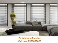 a living room with blinds covering the windows