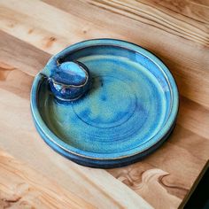 a blue bowl sitting on top of a wooden table