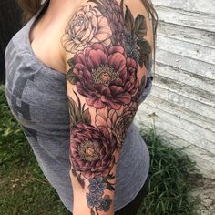 a woman's arm with flowers on it