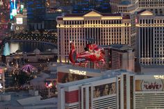 the las vegas strip is lit up at night with neon signs and buildings in the background