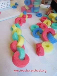 a child is playing with toys on the floor in front of some doughnuts