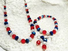 This is the perfect jewelry set for the 4th of July.  It makes a nice gift for someone special for the 4th.  The beads are faucet cut - red, blue and frosted white. They range from 4mm to 12mm in size.  The necklace is 18 inches with a silver chain and lobster claw closure.  The bracelet is 7.5 inches long and the earrings have a 1 inch drop. Patriotic White Jewelry With Colorful Beads, Patriotic Round Beads Jewelry Gift, Patriotic Round Beads Necklace Gift, Patriotic Round Beads Necklace As Gift, Patriotic Jewelry With Colorful Beads As Gift, Red Patriotic Jewelry For Independence Day, Patriotic Colorful Beaded Jewelry Gift, Red Jewelry With Colorful Beads For 4th Of July, Red Jewelry For 4th Of July Gift