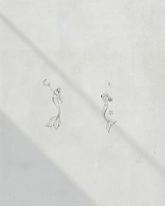 two drawings are shown on the side of a white wall, one is looking up