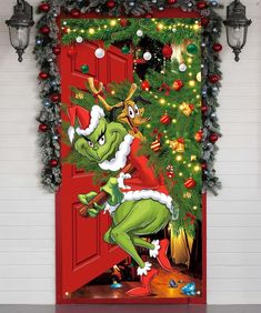 the grinch door cover is decorated with christmas decorations