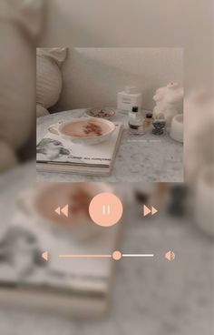 a blurry photo of a book and some other items on a table with an audio player