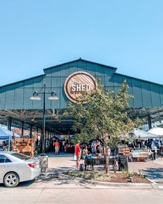 people are standing in front of a building with a sign that says shed on it