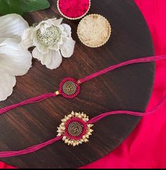 three necklaces on a table with flowers