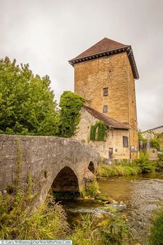 an old brick building with a stone bridge