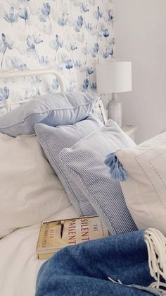 a white bed topped with pillows and blankets