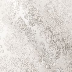 close up view of white and silver wallpaper with floral design on it's surface