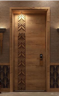 a wooden door with an intricate design on the front and side panels, along with decorative wall sconces