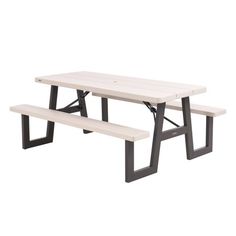 a white picnic table with two benches underneath it