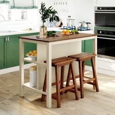 a kitchen island with two stools in front of it