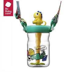 a baby toy in a glass jar with toothbrushes