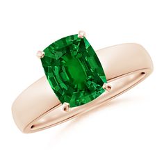 a ring with an emerald stone in it