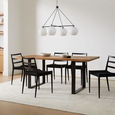 a dining room table with chairs and a chandelier