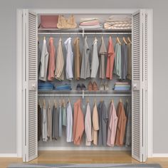 an open closet with clothes and shoes hanging on the rails, next to a rug