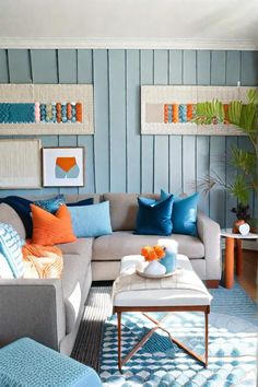 a living room filled with furniture and colorful pillows on top of it's walls