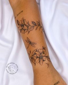 a woman's arm with flowers on it