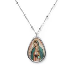 Add a custom touch to what you're wearing with this necklace showing the beautiful painting of Our Lady of Guadalupe  The pendant and its chain are made with robust brass material for dazzling looks that are long-lasting. The print panel is made with aluminum while the pendant itself comes in a unique shape of an ellipse. .: Brass pendant and necklace chain .: Ellipse-shaped pendant .: White aluminum print surface .: Lobster clasp closure Silver Our Lady Of Guadalupe Necklace, Spiritual Our Lady Of Guadalupe Jewelry Gift, Oval Our Lady Of Guadalupe Necklace For Gift, Oval Our Lady Of Guadalupe Necklace Gift, Oval Our Lady Of Guadalupe Jewelry Gift, Spiritual Oval Our Lady Of Guadalupe Necklace, Spiritual Oval Necklace Featuring Our Lady Of Guadalupe, Oval Virgin Mary Jewelry Gift, Virgin Mary Pendant Necklace As Gift