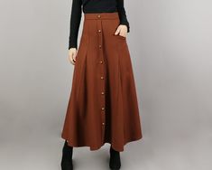 * One maxi wool skirt, fixed waist with zipper on the back. * A-line shape and with bronze color buttons. * Half lined, with one pocket. * Support 7 days return to get full refund on item without any reason. * Can custom size and colors, lead time is 6-8 days; * Let us know your usual size in your country and your overall height. * If you have some specific request or special characters such as broad shoulder, long arms, long waist, etc you think we need pay attention to when making, please let Brown Skirt Long, Long Skirt Vintage, Dark Green Skirt, Skirt Wool, Poncho Jacket, Clothing Aesthetic, Maxi Rok, Brown Skirt, Skirt High Waist