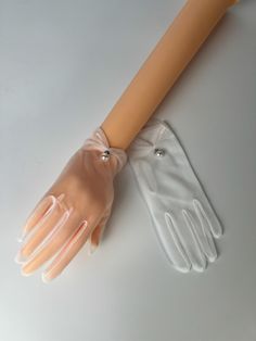 Delicate, high-quality sheer white nylon gloves with stunning pearl attachment. Perfect for brides to wear at formal events such as weddings. Gloves are stretchable and are intended to fit all sizes.  -Touchscreen compatible! Measurements:  Length: 9" Palm width: 3.5"  Wrist opening: 3"  Thank you for visiting our Etsy store! Elegant Fingerless Bridal Accessories For Party, White Sheer Gloves, Classy Gloves, Sheer Gloves, Mesh Gloves, Formal Gloves, Bridal Gloves, Evening Formal, Mitten Gloves