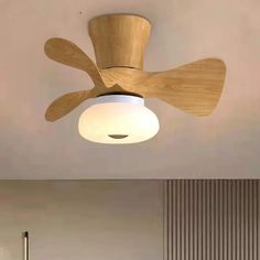 a wooden ceiling fan mounted to the ceiling