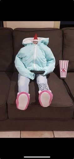 a stuffed animal sitting on top of a brown couch